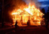 Firefighter CAUGHT Setting Town Ablaze! House engulfed in flames with firefighters present.