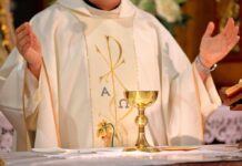 Catholic Bishop Gunned Down in ATTACK – Suspect FLEES! A priest holding a golden chalice during a religious ceremony