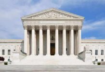 Dem Senator Issues Court-Packing Bombshell Plot! Front view of the Supreme Court building with large columns and steps under a blue sky