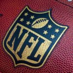 NFL Star Dead – Police Call Release Cause! Close-up of an NFL football with the logo prominently displayed