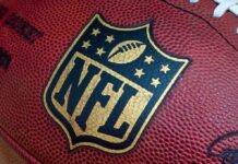 NFL Star Dead – Police Call Release Cause! Close-up of an NFL football with the logo prominently displayed