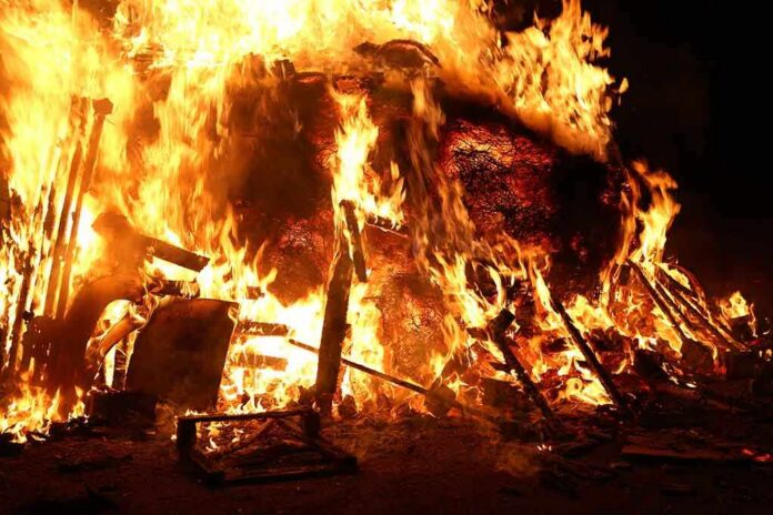 shutterstock_242532967-1 A large fire engulfing debris at night