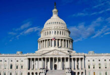 Congress Members Come To Blows On House Floor US Capitol Building against blue sky.