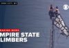 Russian Protest Flag Flown From Empire State Building 2 climbers unfurl banner at top of Empire State Building.