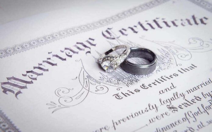 shutterstock_338597486-3- Two wedding rings resting on a marriage certificate
