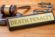 Rapper Given Death Penalty After Guilty Verdict Gavel, handcuffs, and a nameplate reading death penalty on a wooden desk