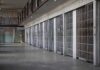 prison cell block with metal barred doors