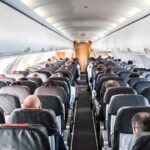 Laptop Ignites Mid-Flight, Cabin Chaos Airplane cabin with passengers seated in rows