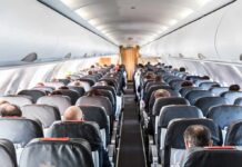 Laptop Ignites Mid-Flight, Cabin Chaos Airplane cabin with passengers seated in rows