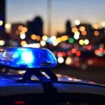 Livestream Turns Execution in Cartel Capital Police car light bar flashing at dusk