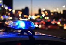 Police car light bar flashing at dusk