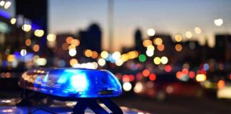 Police car light bar flashing at dusk