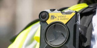 Body-worn camera attached to a high-visibility vest