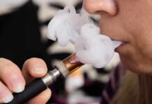 See What Happens To People Who Vape While on GLP1’s Close-up of a person vaping, exhaling smoke clouds