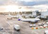 Israel SECRETLY Using Commercial Planes For THIS Airplanes at airport gates during sunset with ground vehicles and jet bridges