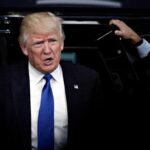 Trump Torches RINO After He Defects to Dem Party man in suit stepping out of a vehicle