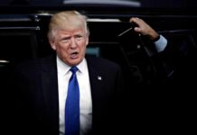 Trump Torches RINO After He Switches Party man in suit stepping out of a vehicle