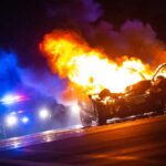 Dashcam Inferno: Cop Shatters Glass, Saves Driver Burning car on a dark street at night
