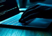 AI Hacks Government Database – Private Records LEAKED! Hand typing on laptop with green code on screen