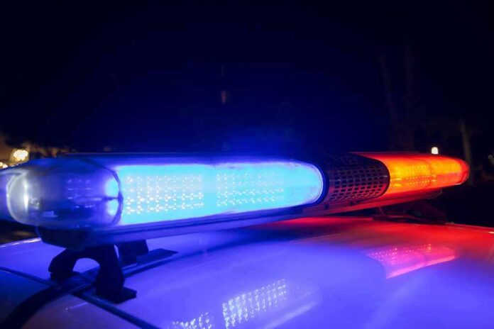 shutterstock_1168252924 Police car light bar flashing blue and red at night
