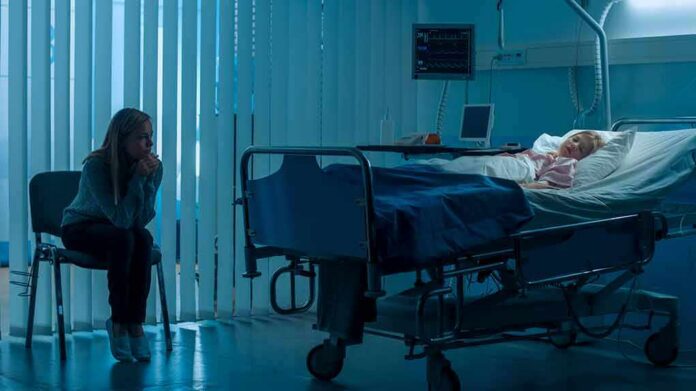 shutterstock_1181842819-1 hospital room with child in bed and adult sitting nearby