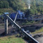 Trump Fulfills Campaign Pledge With $15BN Announcement Coal processing plant with conveyor belts in a forested valley