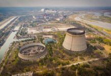 Abandoned cooling towers at a sprawling industrial site