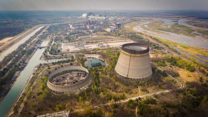 shutterstock_1387140884 Abandoned cooling towers at a sprawling industrial site