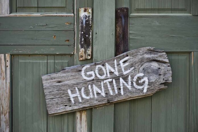 shutterstock_140754364 Weathered wooden sign on green door