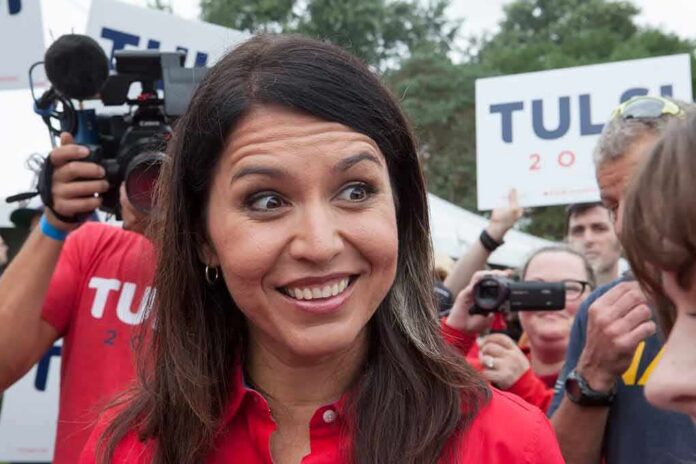 shutterstock_1540763591 Tulsi Gabbard smiling at an outdoor event surrounded by supporters