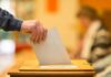 Far-Right Shock Upends German Election Hand placing a ballot into a wooden voting box