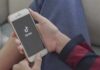 TikTok Ordered To Pay State $100 Million Hands holding a smartphone with a short-video app loading screen