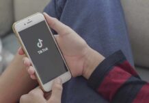 Hands holding a smartphone with a short-video app loading screen