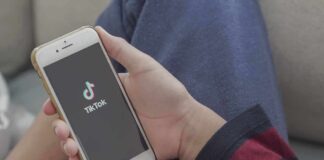 Hands holding a smartphone with a short-video app loading screen