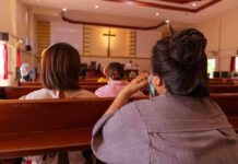Dem Senate Candidate Slanders Virgin Mary, Denies Jesus people seated in church pews facing a cross