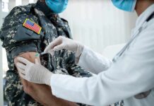 2,544 Mysterious Troop Deaths Under Investigation Healthcare worker giving vaccine to person in military uniform