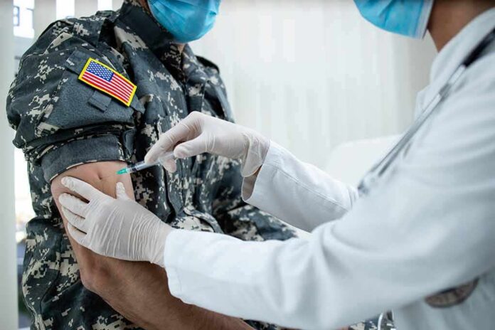 shutterstock_1932896993 Healthcare worker giving vaccine to person in military uniform