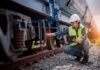 Mile-Deep Nuclear Reactor Infuriates State – Construction Begins Railway inspector checking freight train wheel with tablet