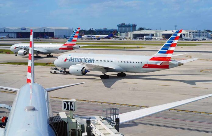 shutterstock_2152349011 American Airlines jets taxi at a busy airport apron