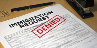Immigration request form with denied stamp on a desk
