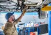 Dashboard Spy Cams Hit Cars — America Next Mechanic inspecting underside of a car on a lift