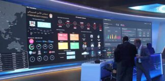 cybersecurity operations room with large data dashboards and people discussing