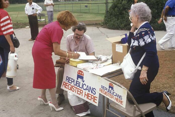 shutterstock_265784873 People at an outdoor voter registration table
