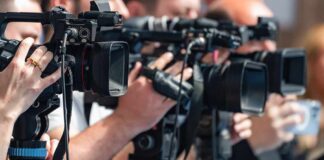 television cameras on tripods at a media event