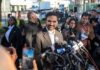 Trump, Mamdani Clash In Heated Press Exchange Zohran Mamdani speaks at a press conference; Julia Bacha is visible among the crowd