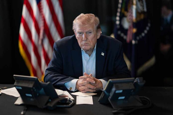 President,Donald,J.,Trump,Oversees,Operation,Epic,Fury,At,Mar-a-lago, Person in suit seated at table with telephones