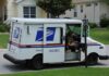 USPS mail truck parked at a suburban mailbox