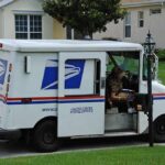 Feds ARREST Mailman – THOUSANDS of Mail Hoarded USPS mail truck parked at a suburban mailbox