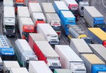 Undercover Immigration Sweep: 95 Truckers Arrested! Trucks in heavy traffic on a multi-lane highway