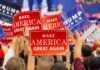 GOP Fuming After Attendees Charged Thousands To Attend Trump’s Rally Crowd holding red and blue campaign signs at a political rally